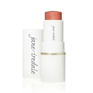 Peach lipstick extended from a white minimalist tube with the cap nearby, brand Jane Iredale visible on the case.