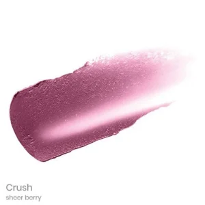 Lipstick swatch in the Crush sheer berry shade on a white background, showing a pink-purple pigment.