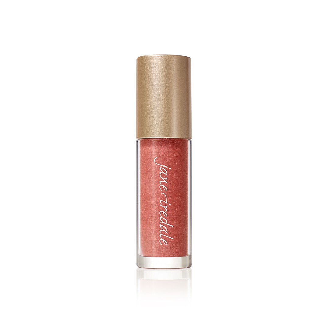 3154467860jpg – Damara Luxury Spa Vancouver Lip gloss bottle in coral shade with a metallic gold cap and brand script along the tube (Jane Iredale).