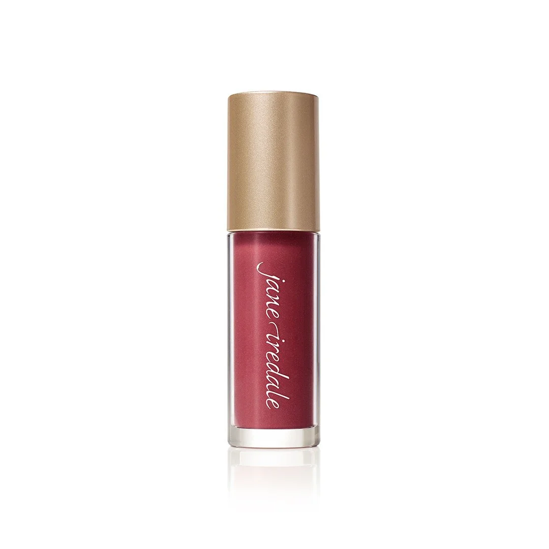 3154476157webp – Damara Luxury Spa Vancouver Red liquid lipstick in a transparent tube with a metallic gold cap, brand name Jane Iredale visible, standing upright with a subtle reflection below