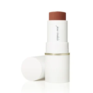 White lipstick tube with brick-red lipstick exposed; cap off and resting beside on a white background.