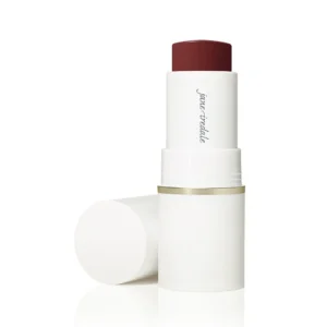 White lipstick tube with burgundy-red lipstick, cap removed and resting nearby, gold band around the base for a clean, minimalist product shot.