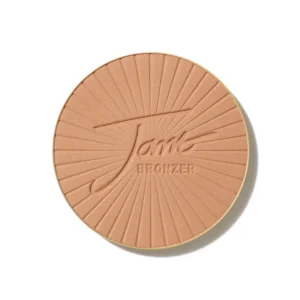 Round bronzer compact with peach pressed powder and a radiating sunburst pattern, embossed 'Jame Bronzer' logo at center.