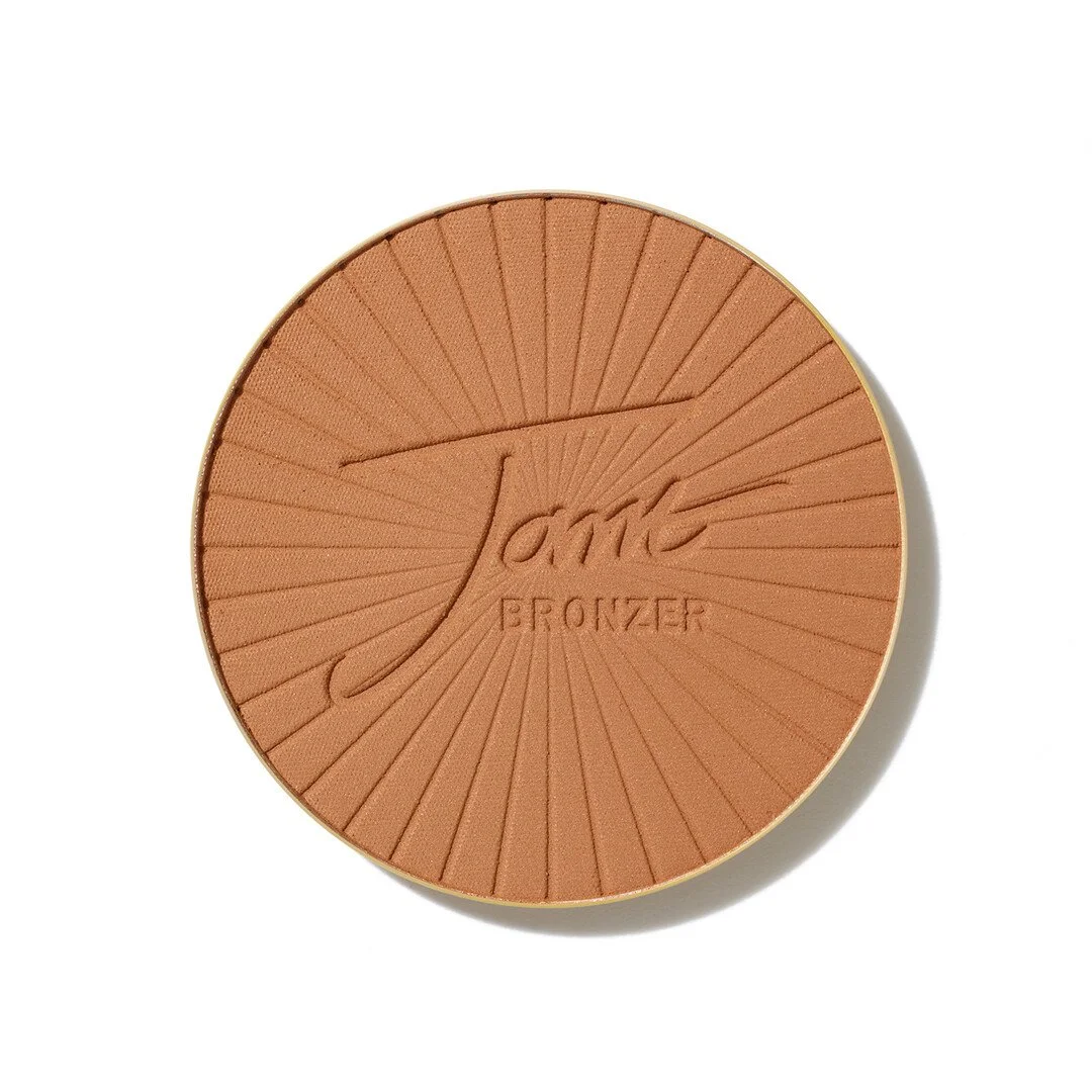 3551034554webp – Damara Luxury Spa Vancouver Round bronzer makeup compact with radiating line pattern and embossed logo at center.