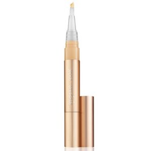 Gold makeup concealer pen with wand applicator extended, cap removed.