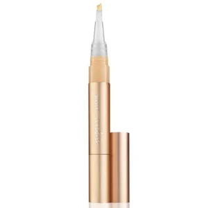 Rose-gold concealer pen with clear applicator wand and cap removed.