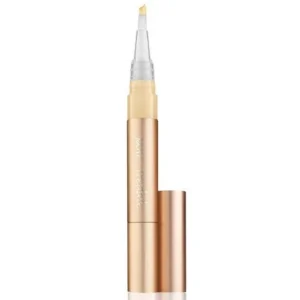 Rose-gold liquid concealer pen with a brush tip and beige cap shown upright, highlighting its slim cosmetic design