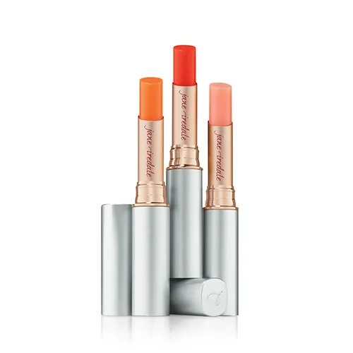 511140489-2webp – Damara Luxury Spa Vancouver Three lipstick tubes in silver cases with orange, coral, and red shades standing upright.