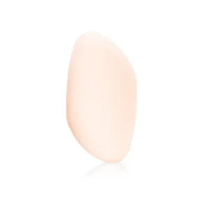 Light peach, oval-shaped object standing upright on a white background with a subtle reflection.