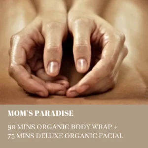Close-up of two hands forming a heart shape in front of a bare chest, on a beige spa services banner that lists packages like 90 mins organic body wrap and deluxe facial.