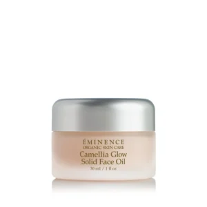 ÉMINENCE Organic Skin Care Camellia Glow Solid Face Oil in a frosted beige jar with a silver cap, product shot