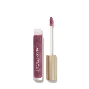 Close-up of a glittery pink-purple lip gloss tube with wand applicator and light-colored cap nearby.
