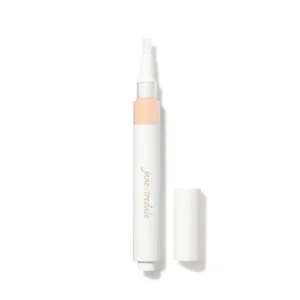 Close-up of a white cosmetic pen with a peach-colored band and the cap removed, tip exposed.
