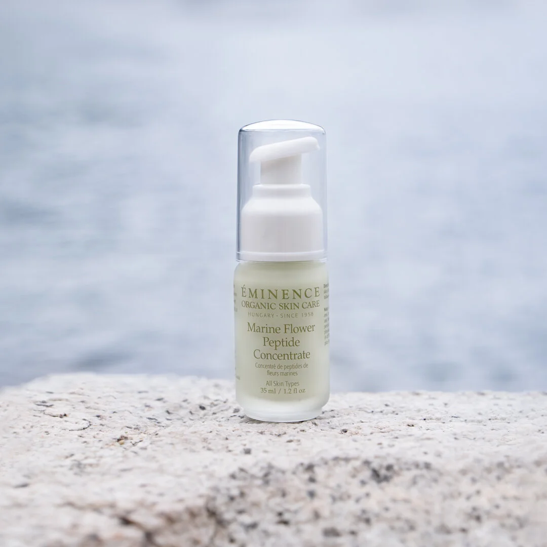Social+Media+Package+1080+x+1080-5 – Damara Luxury Spa Vancouver A skincare serum bottle (Marine Flower Peptide Concentrate) on a textured rock with the ocean blurred in the background.