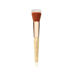 Cosmetic powder brush with fluffy white-tipped bristles and pale wood handle standing upright