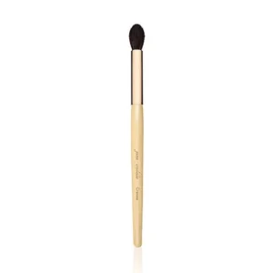 Makeup brush with a light wood handle and dark soft bristles, used to apply makeup like eyeshadow or concealer