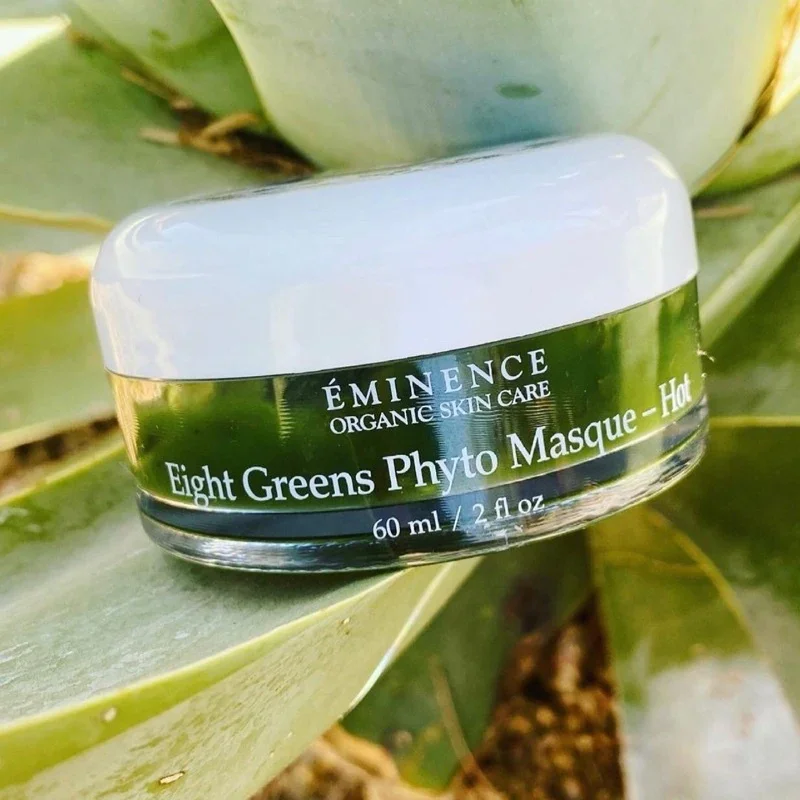 d03590bfbd6dfcc9c8a63a83e1dadd7e – Damara Luxury Spa Vancouver Jar of ÉMINENCE Organic Skin Care Eight Greens Phyto Masque resting on a green plant leaf, 60 ml noted on label