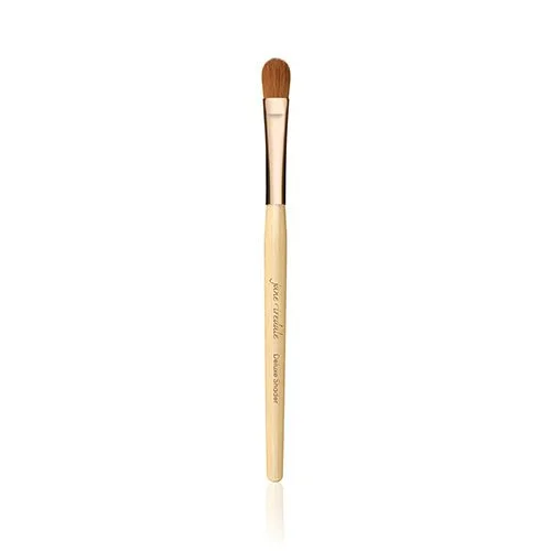 deluxeshaderwebp – Damara Luxury Spa Vancouver Single makeup brush with a light wooden handle, copper ferrule, and brown bristles on a white background.