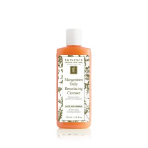 Product bottle of Éminence Mangosteen Daily Resurfacing Cleanser with orange liquid and white cap
