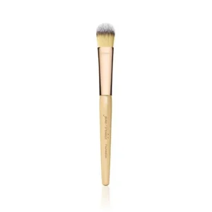 Cosmetic makeup brush with a light wooden handle and fluffy white-tipped bristles on a white background.