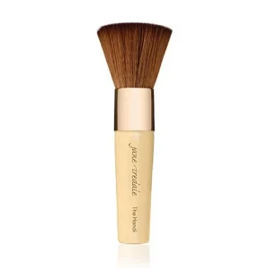 Jane Iredale makeup brush with a wooden handle and dense brown bristles, standing upright.