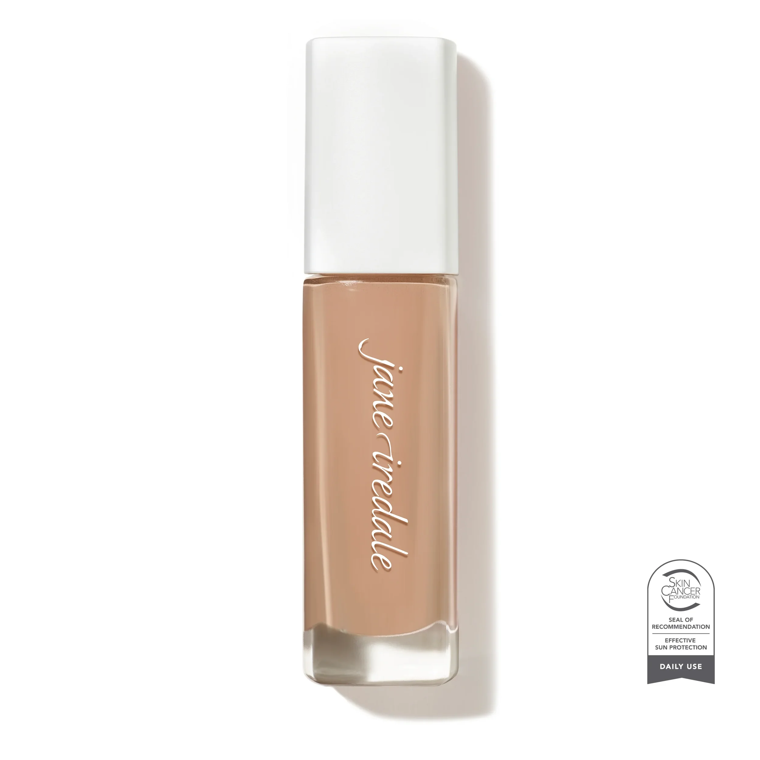 jane-iredale-Skintuition_34_Light_Medium_Soldier_SCF_5000xwebp – Damara Luxury Spa Vancouver Close-up of a nude lipstick tube with a white cap, beige-brown shade visible at the base and a Skin Cancer Foundation seal in the bottom-right corner.