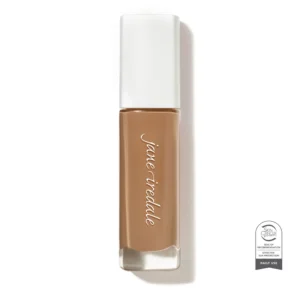 Close-up of a brown lipstick in a white cap standing upright, with a Skin Cancer Foundation seal visible at the bottom right.