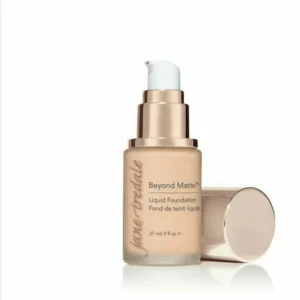 Bottle of Jane Iredale Beyond Matte Liquid Foundation with pump, beige shade, 27 ml, with cap resting beside it on a white background