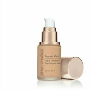 Beige liquid foundation bottle with pump, labeled 'Beyond Matte,' cap resting beside it on a white background.