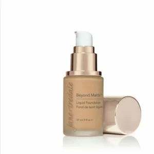 Bottle of Jane Iredale Beyond Matte liquid foundation with pump, beige shade, cap set beside on white background.