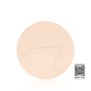 Beige circular facial sheet mask with a textured surface and a visible 'Recommended Daily Use' label from the Skin Cancer Foundation.