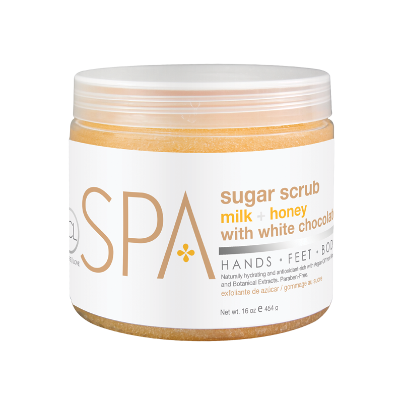 suger-scrub-milk-honey-16ozwebp – Damara Luxury Spa Vancouver Cosmetic sugar scrub jar with label reading 'milk + honey with white chocolate' and 'Spa' branding, 16 oz (454 g) inside a clear amber jar