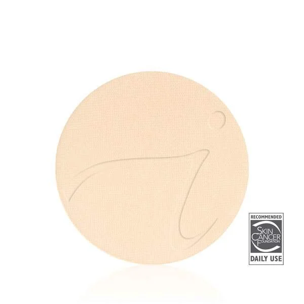 warmsiennawebp – Damara Luxury Spa Vancouver Beige pressed powder compact with a subtle decorative line on its surface and a small circular mark, featuring a Skin Cancer Foundation Daily Use logo in the corner.